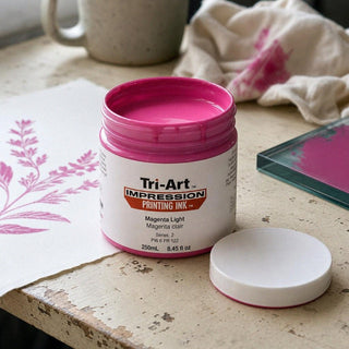 Encre de sérigraphie Tri-Art Magenta Light en pot ouvert avec échantillon d'imprimé floral